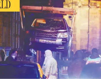  ?? THILO SCHMUELGEN / THILO SCHMUELGEN ?? Workers remove a vehicle that crashed into pedestrian­s in Trier, Germany, on Tuesday. According to one prosecutor, the driver, who has been arrested, had consumed a large amount of alcohol before the crash that claimed four lives.