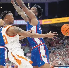  ?? ERIC GAY/ASSOCIATED PRESS ?? Texas guard Sir’Jabari Rice, left, passes the ball around Kansas forward K.J. Adams Jr. during the second half of the Longhorns’ win on Saturday in Austin, Texas.