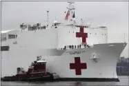  ?? KATHY WILLENS ?? In this March 30, 2020 file photo, the U.S. Navy hospital ship USNS Comfort is escorted up the Hudson River on its way to New York City. On Tuesday, April 21, 2020, while expressing confidence that stresses on New York City’s hospital system are easing, New York Gov. Andrew Cuomo said that the ship deployed to New York City to help fight the coronaviru­s outbreak is no longer needed.