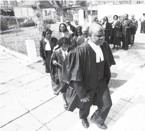  ?? FILE ?? Former president of the Jamaican Bar Associatio­n, Ian Wilkinson, leading fellow attorneys into the East Queen Street Baptist Church.