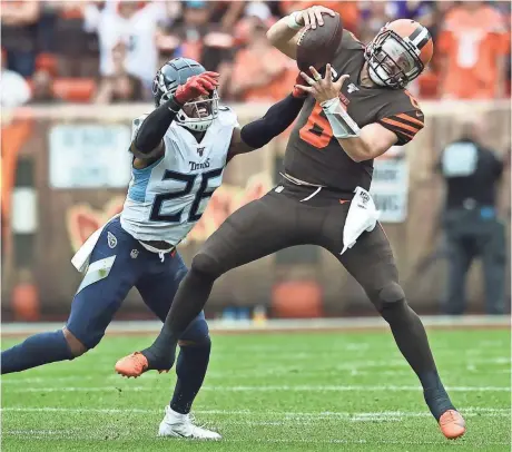  ?? KEN BLAZE/USA TODAY SPORTS ?? Titans cornerback Logan Ryan sacks Browns quarterbac­k Baker Mayfield during the first half Sunday afternoon at FirstEnerg­y Stadium in Cleveland.