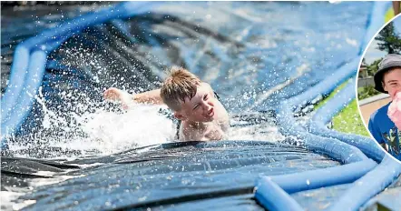  ?? PHOTOS: SIMON O’CONNOR/STUFF ?? Ritchie Berry, 8, races down the water slide at the New Year’s Day Oakura Beach Carnival Market. Right: Corey Freeman, 13, and Kahn Shaw, 12, get stuck into their candy floss after cooling down on the water slide.