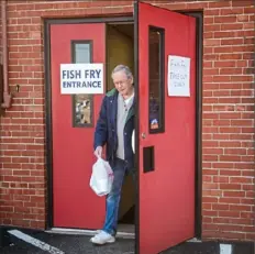  ?? Pam Panchak/Post-Gazette ?? Bill Scheirer, of Kennedy, heads home with his to-go order from St. Malachy Catholic Church in Corapolis on Friday.