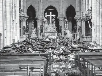  ?? CHRISTOPHE PETIT TESSON/GETTY-AFP ?? Debris litters the inside of Notre Dame Cathedral on Tuesday after an inferno engulfed the landmark Monday in Paris.