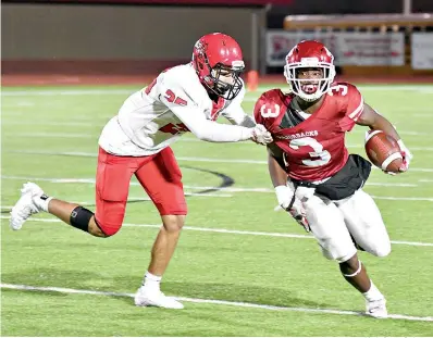  ?? Photo by Kevin Sutton ?? ■ Arkansas High running back Torie Blair (3) tries to escape the grasp of a Maumelle defender during first half action Friday at Razorback Stadium in Texarkana, Ark.