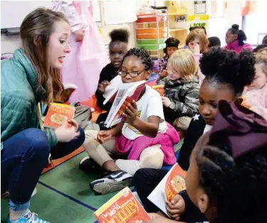  ??  ?? Sudduth Elementary first grade teacher Mary Robert Gannon hands out copies of “The World According to Humphrey” to her students Friday. ALL elementary students district-wide will read the book together. (Photo by Charlie Benton, SDN)