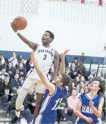  ?? BOB TYMCZYSZYN/THE STANDARD ?? Jean Vanier’s Phil Angervil (3) drives to the hoop against Port Colborne Bears Stephen Kapellas (12) during the Tribune basketball tournament Thursday.