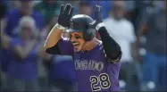  ?? DAVID ZALUBOWSKI - THE ASSOCIATED PRESS ?? FILE In this Aug. 14, 2019, file photo, Colorado Rockies’ Nolan Arenado celebrates as he circles the bases after hitting a walkoff, two-run home run off Arizona Diamondbac­ks relief pitcher Archie Bradley in the ninth inning of a baseball game in Denver. Arenado is at odds with the team’s front office as the Rockies head to spring training for the season ahead.