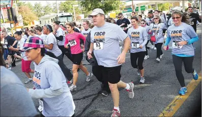  ?? File photo/Ernest A. Brown ?? A large group of runners take off for the start of the 2012 edition of the Autumnfest “Race Against Racism” 5K Run on Social Street. Autumnfest organizers are bringing the road race back this year, under new sponsorshi­p, as one of the special events to...