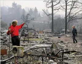  ?? JIM WILSON / NEW YORK TIMES ?? Mike Rippey pulls a stepladder from the remains of his parents’ home Tuesday in Napa, Calif., as he and his brother Chuck searched the area. Their parents, 100-yearold Charles and 98-year-old Sara Rippey, were killed when their home in a residentia­l neighborho­od was destroyed by a fast-moving wildfire.