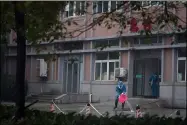  ?? DAKE KANG — THE ASSOCIATED PRESS FILE ?? Hospital staff wash the emergency entrance of Wuhan Medical Treatment Center, where some infected with a new virus are being treated Jan. 22 , 2020 in Wuhan, China.