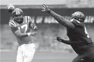  ?? Associated Press ?? n Virginia Tech quarterbac­k Josh Jackson (17) has his pass rushed by defensive lineman Tim Settle (4) during an NCAA college football spring game April 22 in Blacksburg, Va. Virginia Tech coach Justin Fuente announced Monday that Jackson will start the...