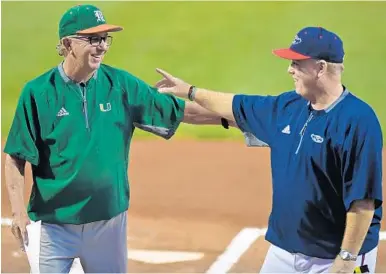  ?? JIM RASSOL/STAFF FILE PHOTO ?? In February, University of Miami head coach Jim Morris, left, and Florida Atlantic University head coach John McCormack greeted each other before a game in Boca Raton.