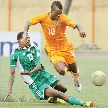  ??  ?? Ivory Coast’s forward Ahmed Cheick Moukoro (R) vies for the ball with Nigeria’s Rabiu Ali (L) during the 2014 African Nations Championsh­ip (CHAN) on July 27, 2013