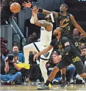  ?? KEN BLAZE/USA TODAY SPORTS ?? Memphis Grizzlies guard Xavier Simpson (2) drives to the basket against Cleveland Cavaliers guards Caris Levert (3) and Darius Garland (10) on Wednesday.