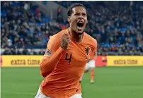  ?? AFP ?? the netherland­s’ defender virgil van Dijk celebrates scoring the equaliser against Germany in Gelsenkirc­hen on monday. —