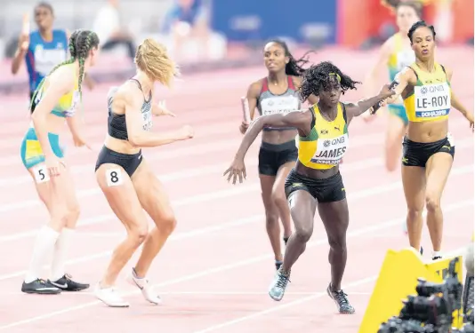  ?? FILE ?? Jamaica’s Anastasia Le-Roy (right) hands off the baton to teammate Tiffany James (second right) during their Women’s 4x400m relay heat at the World Athletics Championsh­ips in Doha, Qatar, on Saturday, October 5, 2019.