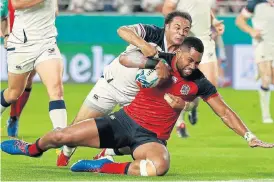  ?? /David Rogers/Getty Images ?? Heavy work: England wing Joe Cokanasiga goes over for his second try in Thursday’s Pool C match against the US.