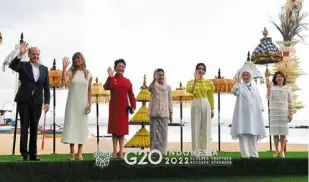  ?? ?? (From left) Britain’s Prime Minister Rishi Sunak and Crown Prince Mohammed bin Salman of Saudi Arabia chatting at the G20 Summit. Spouses of world leaders posing for a group photo amid the beautiful background of Nusa Dua, Badung, Bali. India’s Prime Minister Narendra Modi walks past people playing musical instrument­s during a leaders lunch at the G20 Summit. — Ap/reuters