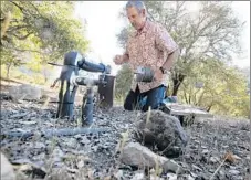  ??  ?? RAY WALDBAUM checks the water level of the well at his home near Santa Rosa. It had dropped 10 feet since May.