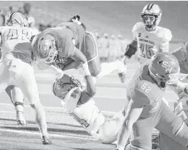  ?? Gene Schallenbe­rg / Huntsville Item ?? Sam Houston State running back Corey Avery, who rushed for 129 yards, dives into the end zone and the Bearkats went on to survive a late Kennesaw State comeback.