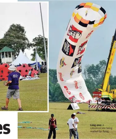  ??  ?? Long one: A cylindrica­l kite being readied for flying.