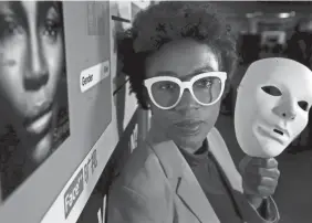  ?? STEVEN SENNE/AP ?? Massachuse­tts Institute of Technology facial recognitio­n researcher Joy Buolamwini holds a white mask she had to use so that software could detect her face.