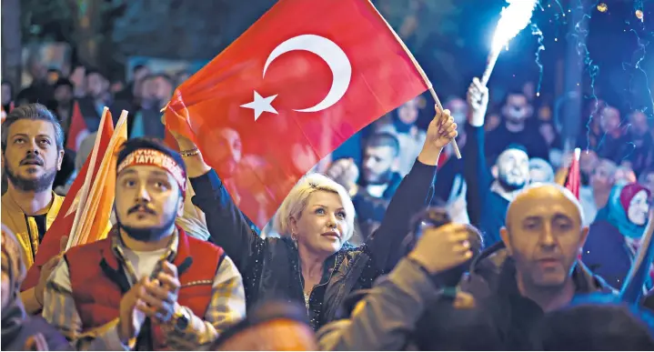  ?? ?? Supporters of Recep Tayyip Erdogan, left, celebrate in Istanbul, above