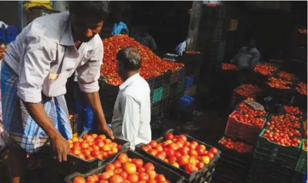  ?? Photos: India TV/Getty Images ?? A hike in the price of tomatoes is making life hard for many.