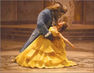  ?? Associated Press photos ?? This image released by Disney shows Dan Stevens as The Beast, left, and Emma Watson as Belle in a liveaction adaptation of the animated classic “Beauty and the Beast.” Luke Evans appears in a scene from “Beauty and the Beast.”