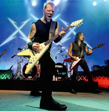  ?? ?? Above Metallica’s James Hetfield (left) and Kirk Hammett letting their Flying Vs do the talking