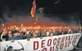  ?? AFP ?? Armenian opposition supporters march during an anti-Russia rally in Yerevan on Wednesday.