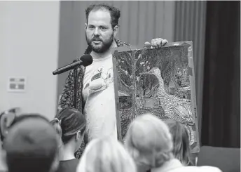  ?? Kin Man Hui / Staff photograph­er ?? Artist Daniel Armstrong shows a drawing depicting the plight of the birds in Brackenrid­ge Park at a hearing hosted by the San Antonio Parks and Recreation and Public Works department­s.