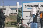  ??  ?? Bekim Mehmedi (center), with other Amazon workers during Wednesday’s walkout.