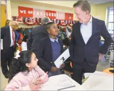  ?? Erik Trautmann / Hearst Connecticu­t Media ?? Gov. Ned Lamont tours Tracey Elementary School in Norwalk with fifth-grader Adrien Danso on Jan. 16.