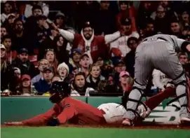  ?? BARRY CHIN/GLOBE STAFF ?? Kiké Hernández dives headfirst into home, scoring the tying run for the Red Sox in the eighth inning.