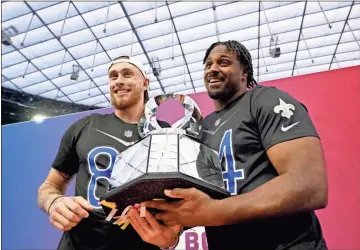  ?? USA Today Sports - Lucas Peltier ?? 49ers tight end George Kittle, left, and Saints defensive end Cameron Jordan hold the trophy following the NFC’S win over the AFC win in the Pro Bowl Games on Sunday in Las Vegas.