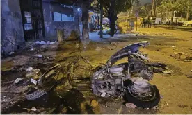  ?? Photograph: Arbab Ali/AP ?? The remains of a motorcycle lie in a street after communal violence in Delhi on Sunday.