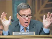  ?? MARK WILSON / GETTY IMAGES ?? Sen. Mark Warner, D-Va., questions former Equifax CEO Richard Smith during a hearing in Washington, D.C., on Wednesday. Equifax had disclosed on Sept. 7, along with the hacking incident, that three top executives sold $1.8 million in company stock. The...