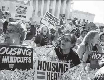  ?? Kevin Wolf Associated Press ?? ADVOCATES for the homeless rally outside the Supreme Court on Monday, where the justices were hearing arguments on whether cities can criminaliz­e sleeping on the street. A ruling is expected by late June.