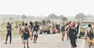  ?? — Reuters photo ?? Yemeni government fighters gather around armoured vehicles during heavy fighting in this still image taken from video.