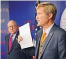  ?? JIM THOMPSON/JOURNAL ?? Mayor Tim Keller holds up a copy of the letter that the city is sending to BYD. Director of Transit Bernie Toon stands next to the mayor.