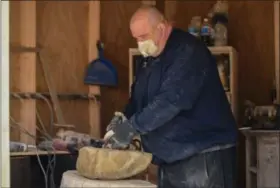  ?? ERIC BONZAR — THE MORNING JOURNAL ?? Fifty-year-old Randy Parsh chisels away at a piece of sandstone, while working out of his home-based shop, April 5.