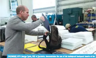  ??  ?? POCOMOKE CITY: George Tunis, CEO of Hardwire, demonstrat­es the use of his bulletproo­f backpack inserts at his factory in Pocomoke City, Maryland. —FP