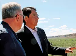  ?? HANNAH GROVER/FARMINGTON DAILY TIMES FILE PHOTO ?? Navajo Nation President Jonathan Nez, right, and Interior Secretary David Bernhardt look out over Pueblo Bonito in May at Chaco Culture National Historical Park. Navajo Nation delegates voted Thursday to support a buffer around the park only half the size of the one proposed in legislatio­n pending in Congress.