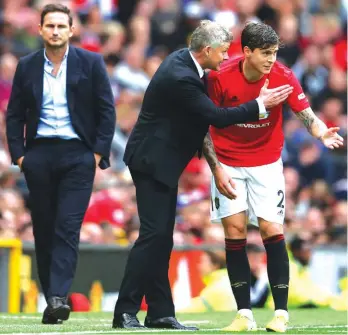  ??  ?? Chelsea’s head coach Frank Lampard, left, watches as Manchester United’s manager Ole Gunnar Solskjaer, centre, talks to his player Victor Lindelof Photo: AP