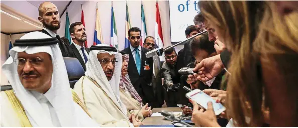  ??  ?? Output deal: Al-Falih, second left, speaks to reporters ahead of the Opec meeting in Vienna. Opec and its allies reached a preliminar­y agreement in the face of strong opposition from Iran to boost production. — Bloomberg