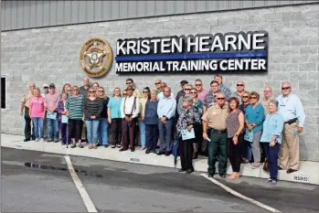  ?? Olivia morley ?? This October 2021 file photo shows Floyd County sheriff’s deputies, former law enforcemen­t officers and their families at the dedication of the Kristen Hearne Memorial Training Center.