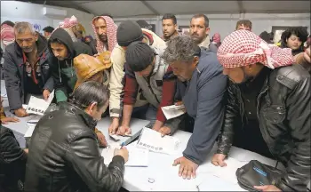  ?? RAAD ADAYLEH — THE ASSOCIATED PRESS ?? Syrian refugees register at an employment office on Sunday at the Azraq refugee camp east of Amman, Jordan.