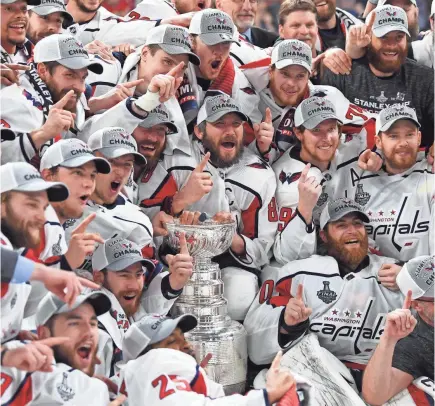  ?? STEPHEN R. SYLVANIE/USA TODAY SPORTS ?? Capitals players celebrate the franchise’s first Stanley Cup championsh­ip after defeating the Golden Knights in five games.